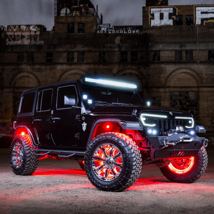 Three quarters view of black Jeep in front of a warehouse, with multiple ORACLE Lighting products installed.