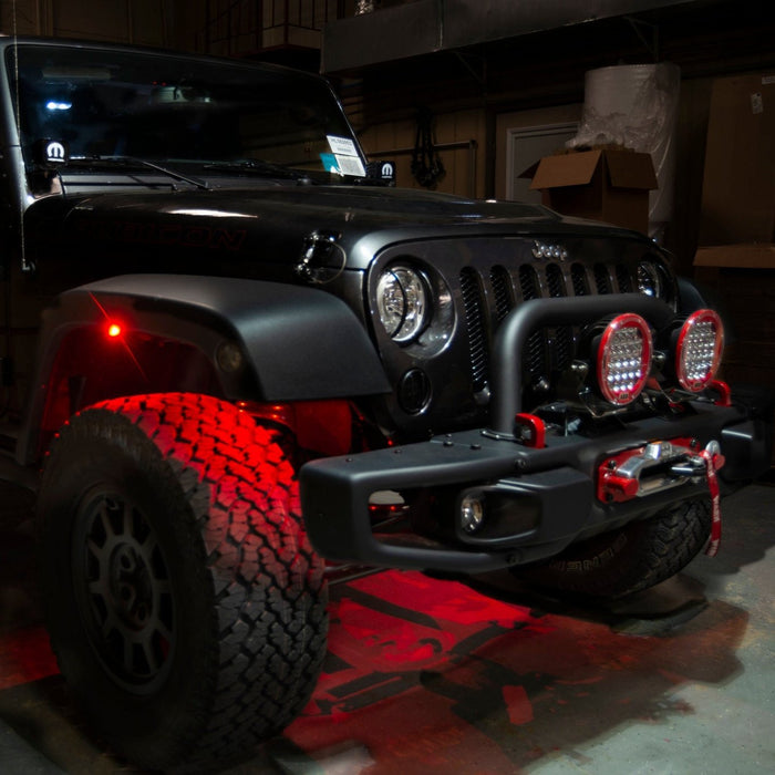 Black Jeep with red LED rock lights installed.