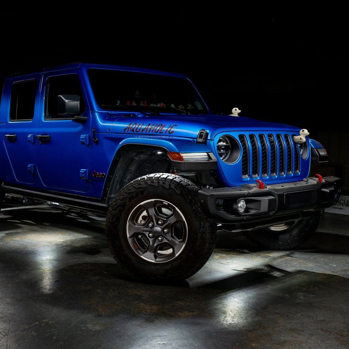 Blue Jeep Gladiator JT with white rock lights installed.