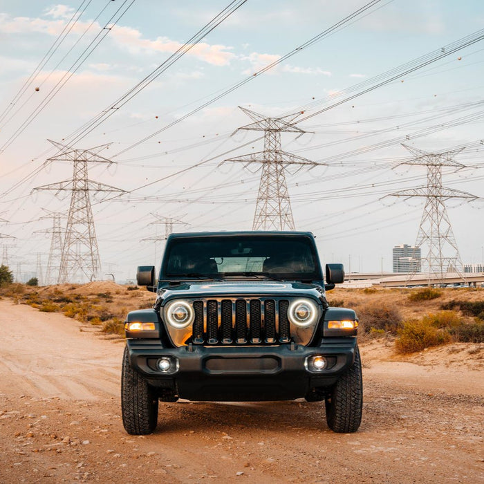 Front view of Jeep Wrangler JL with multiple ORACLE Lighting products installed, including Oculus Headlights and High Performance 20W LED Fog Lights.