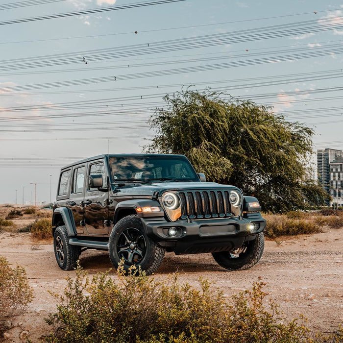 Three quarters view of a Jeep Wrangler in the sand with High Performance 20W LED Fog Lights installed.