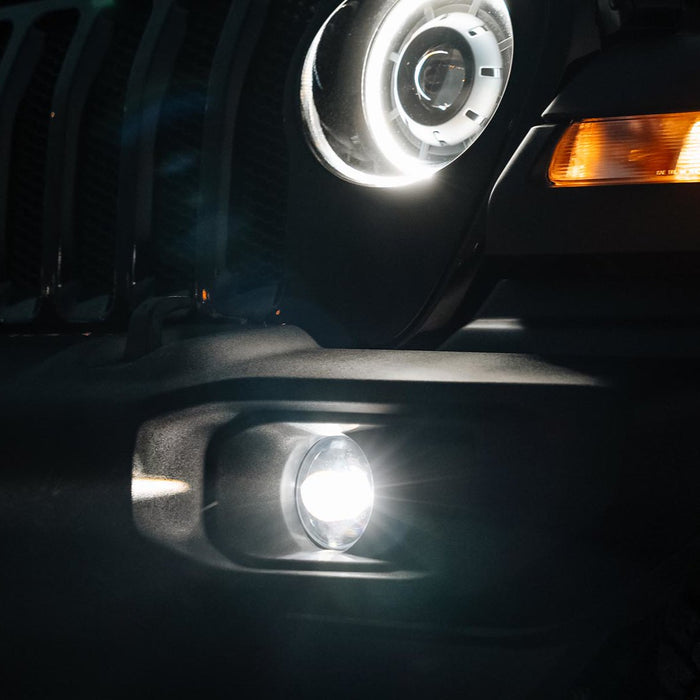 Front end of a Jeep with High Performance 20W LED Fog Lights installed and turned on.