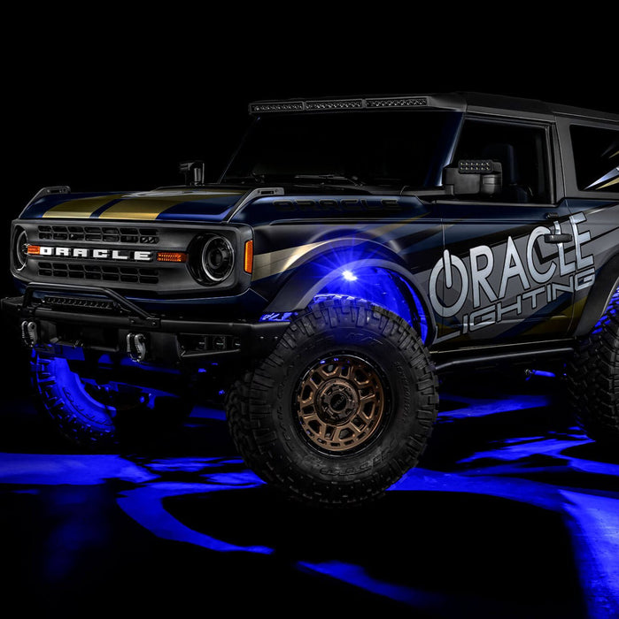 Three quarters view of wrapped Ford Bronco with blue LED rock lights installed