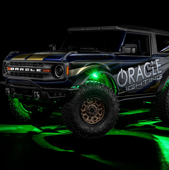 Three quarters view of wrapped Ford Bronco with green LED rock lights installed