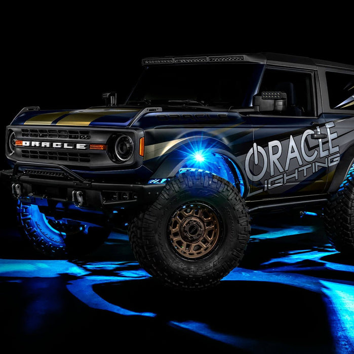 Three quarters view of wrapped Ford Bronco with cyan LED rock lights installed