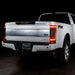 Rear three quarters view of a white Ford Superduty with Flush Mount Tail Lights installed, and brake lights on.