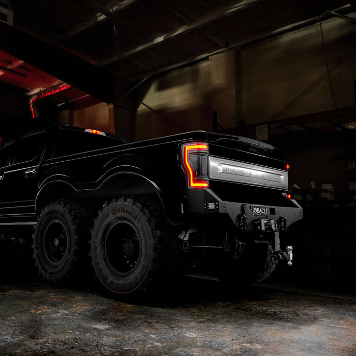 Rear three quarters view of a black Ford Superduty with Flush Mount Tail Lights installed, and brake lights on.