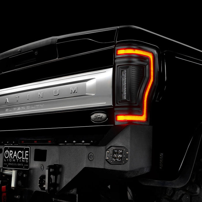 Close up on the rear end of a black Ford Superduty, with Flush Mount Tail Lights installed, with DRLs on.