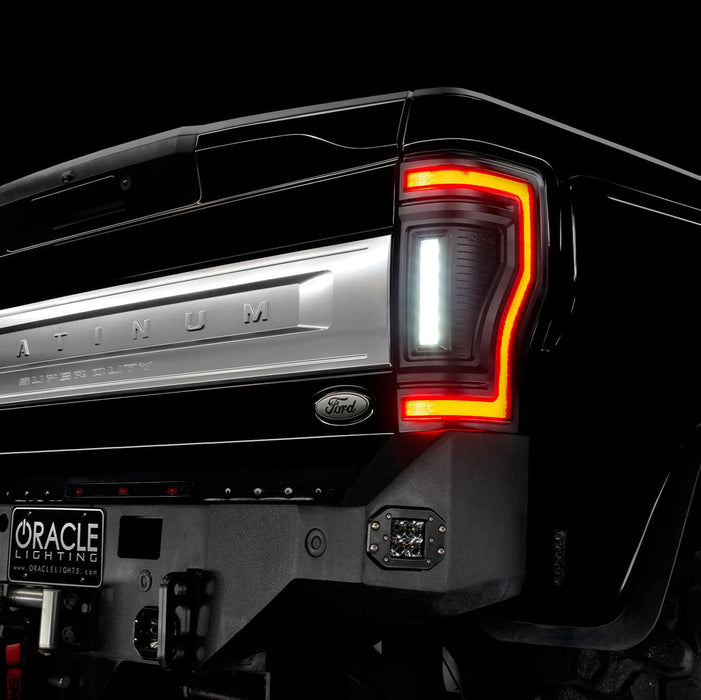 Close up on the rear end of a black Ford Superduty with Flush Mount Tail Lights installed, and reverse lights on.