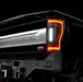 Close up on the rear end of a black Ford Superduty with Flush Mount Tail Lights installed, and reverse lights on.