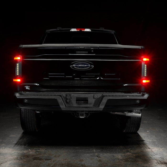 Straight rear view of black Ford F-150 with Flush Style LED Tail Lights installed and running lights on