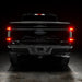 Straight rear view of black Ford F-150 with Flush Style LED Tail Lights installed and running lights on