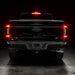 Straight rear view of black Ford F-150 with Flush Style LED Tail Lights installed and brake lights on