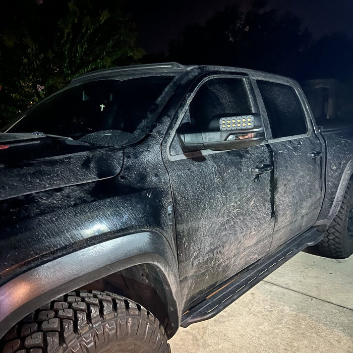 A dirty RAM TRX with LED Off-Road Side Mirror Ditch Lights installed.