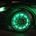 Close-up view of green LED wheel rings installed on a Mustang.