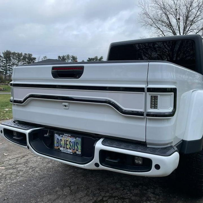 White Jeep Gladiator JT with a white Racetrack Flush Style LED Tailgate Panel Light installed.