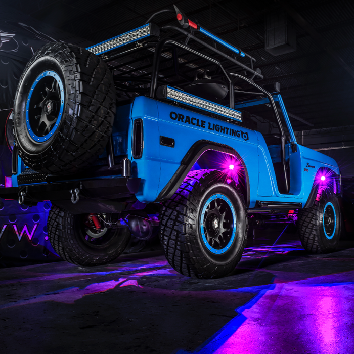 Blue ORACLE Lighting Jeep with purple rock lights shining.