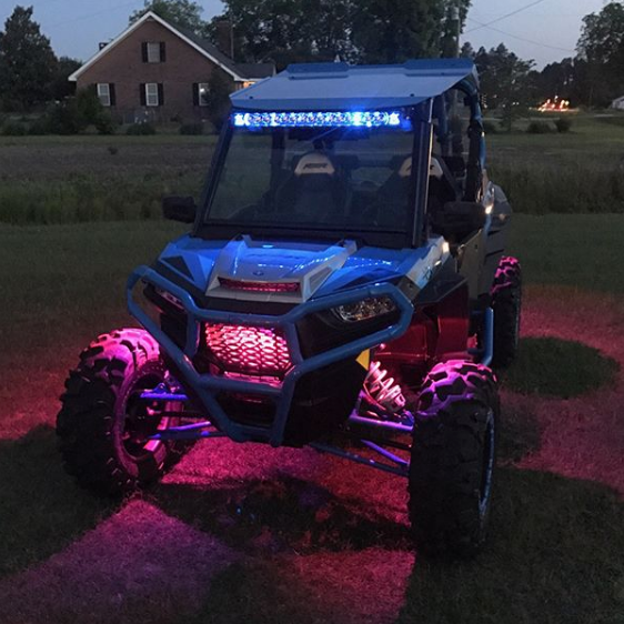 A Polaris with pink rock lights glowing.