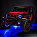 Red Jeep with blue wheel rings.