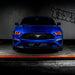 Straight front view of a blue Ford Mustang with red LED headlights.