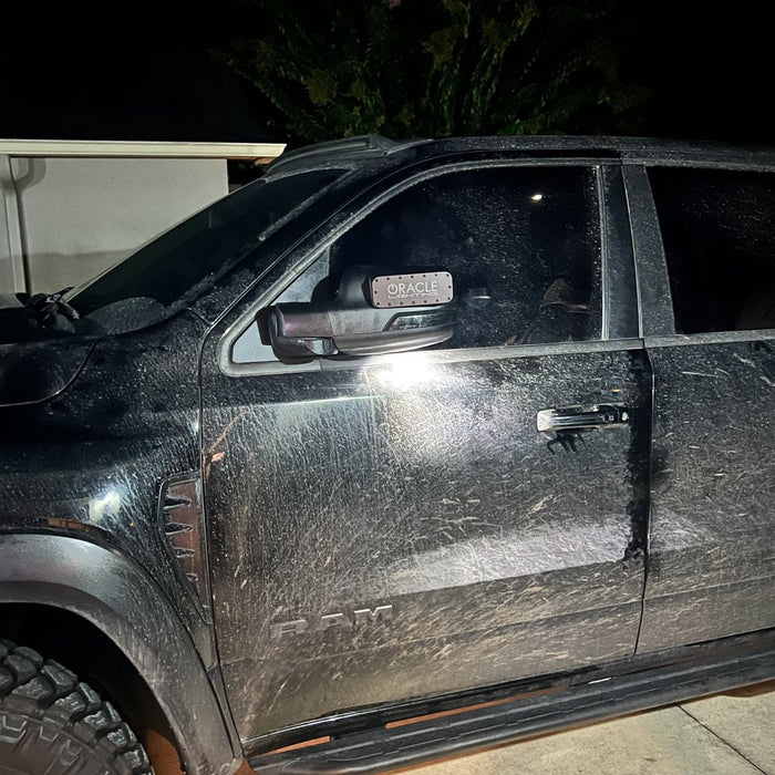 LED Off-Road Side Mirror Ditch Lights installed on a RAM TRX, with the ORACLE Lighting magnetic lens cover attached.