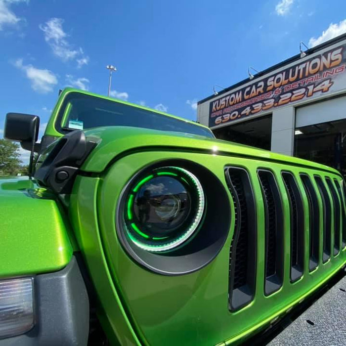 Close-up on a ColorSHIFT Oculus Headlight installed on a Jeep, with green halos on.