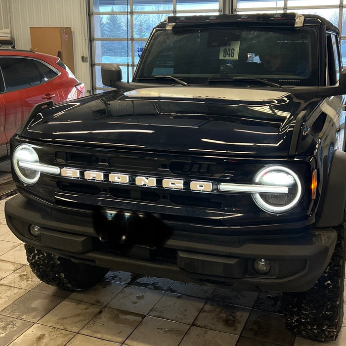 Front view of a Ford Bronco with Universal Illuminated LED Letter Badges installed.