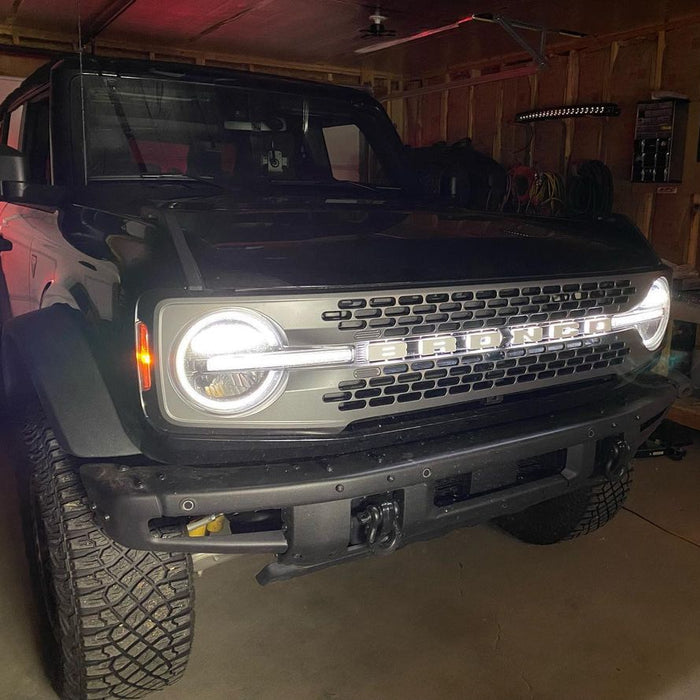 Close-up on the front end of a Ford Bronco with Universal Illuminated LED Letter Badges installed.