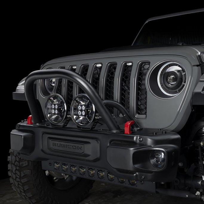 Front end of a Jeep with multiple ORACLE Lighting products installed, including LED Integrated Skid Plate, Oculus Headlights, and 9" Spotlights.