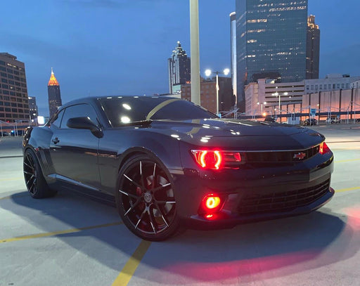 Three quarters view of a Chevrolet Camaro with red LED headlight and fog light halo rings installed.