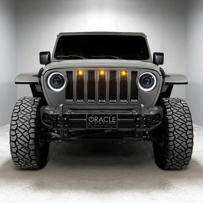 Front end of a Jeep with Oculus Headlights installed, with white LED halos.