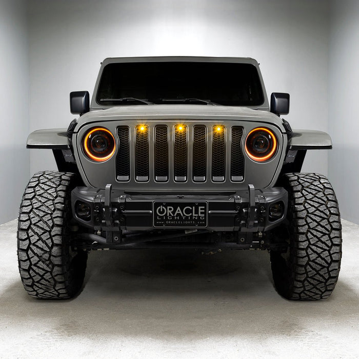 Front end of a Jeep with Oculus Headlights installed, with amber LED halos.