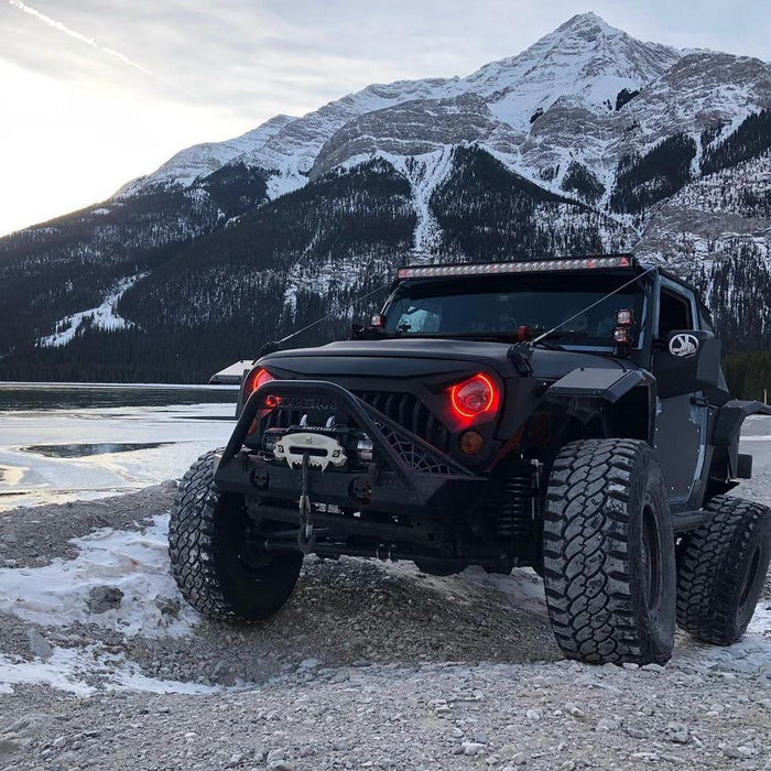 Three quarters view of a Jeep Wrangler with 7" High Powered LED Headlights and red LED halo rings on.