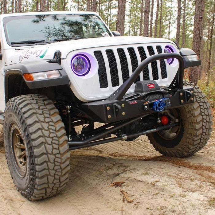 Three quarters view of a Jeep Gladiator with 7" High Powered LED Headlights installed, and purple halo rings on.