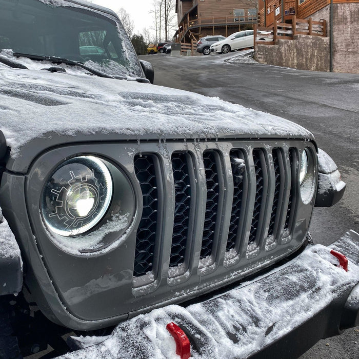 Close-up of oculus heated lens installed on snowy jeep