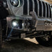 Close-up on the front bumper of a Jeep, with High Performance 20W LED Fog Lights installed.