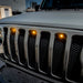 Front end of a Jeep Wrangler JL with amber Pre-Runner Style LED Grill Light Kit installed.