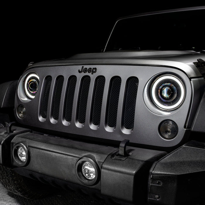 Close-up on the front end of a Jeep Wrangler JK with 7" Oculus Switchback Headlights installed and set to white LED.