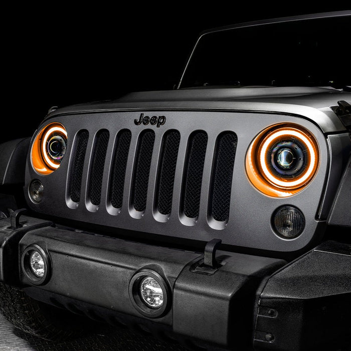 Close-up on the front end of a Jeep Wrangler JK with 7" Oculus Switchback Headlights installed and set to amber LED.