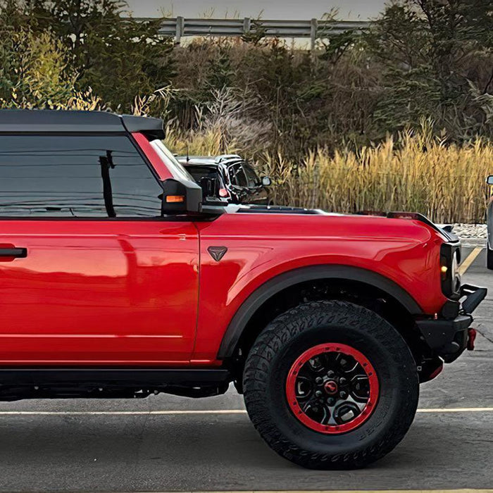 Side view of a red Ford Bronco with Integrated Windshield Roof LED Light Bar System installed.