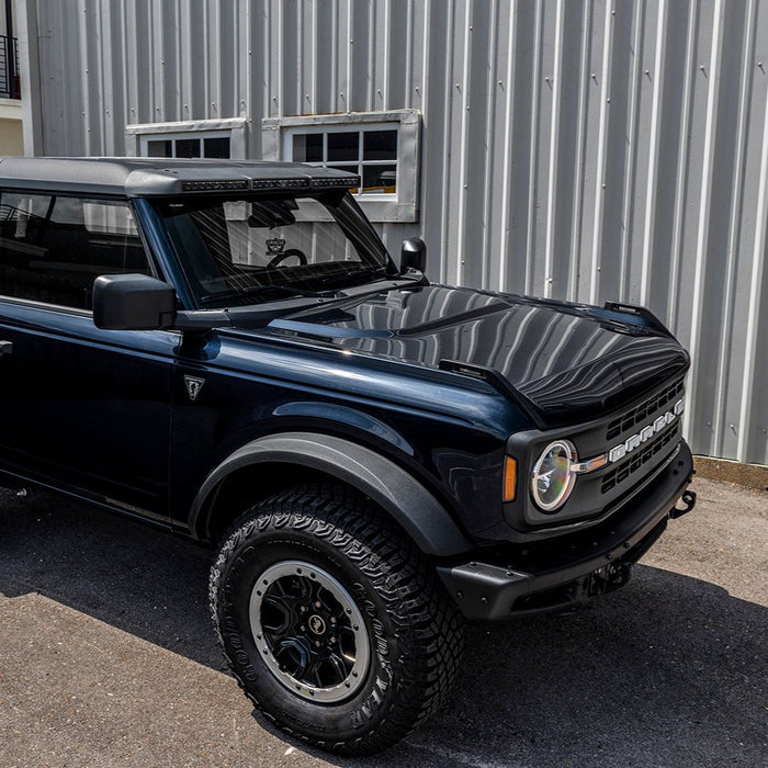 Blue Ford Bronco in a parking lot with Integrated Windshield Roof LED Light Bar System installed.