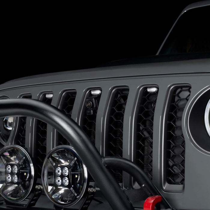 Close-up of a Universal Pre-Runner Style LED Grill Light Kit with clear lens installed on Jeep Wrangler.