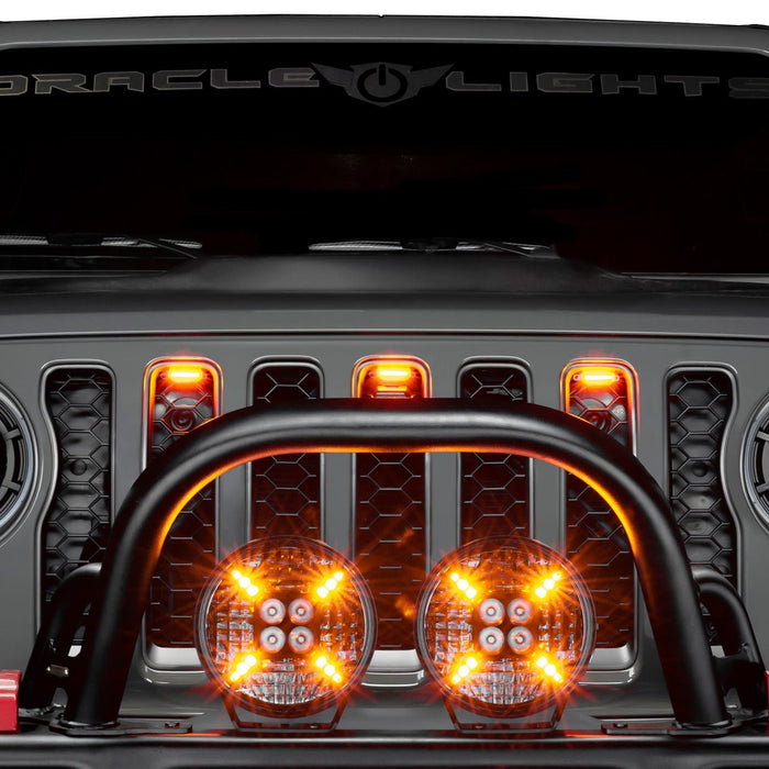 Front grill of a Jeep Wrangler with Universal Pre-Runner Style LED Grill Light Kit installed and amber LEDs turned on.