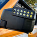 Extreme close-up of LED Off-Road Side Mirrors installed on an orange Ford Bronco.