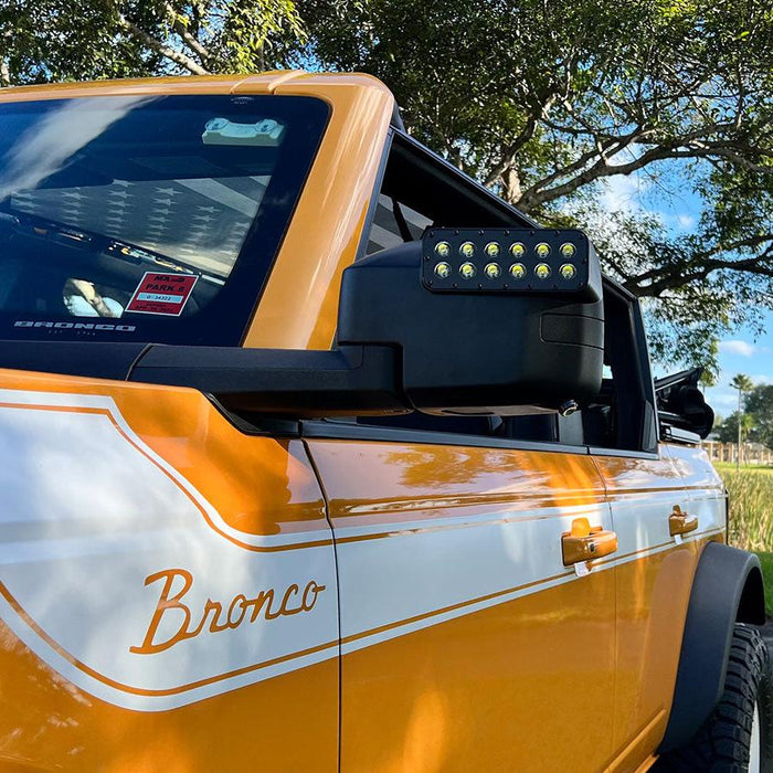 Close-up of LED Off-Road Side Mirrors installed on orange Ford Bronco.