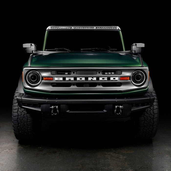 Straight front view of a Ford Bronco with multiple ORACLE Lighting products installed, including Oculus Headlights, LED Off-Road Side Mirrors, and Integrated Roof Light Bar.