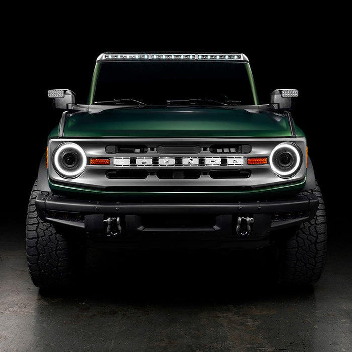 Straight front view of a Ford Bronco with multiple ORACLE Lighting products installed, including Oculus Headlights, LED Off-Road Side Mirrors, and Integrated Roof Light Bar.