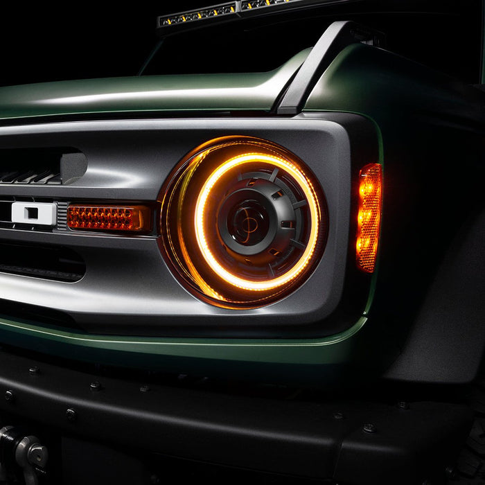 Close-up of a Ford Bronco grill with Oculus Headlights installed, and amber DRLs turned on.