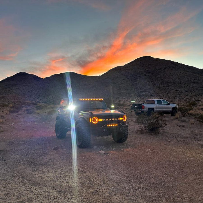 ORACLE Lighting Bronco with amber LED lighting products in the desert with silver truck.