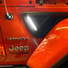 Close-up of Sidetrack™ LED Lighting System installed on a Jeep, with white LEDs on.